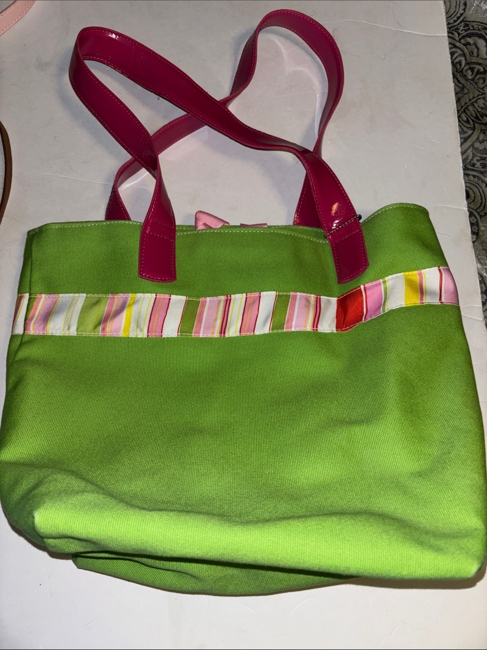 GREEN COLORED CANVAS TOTE BAG WITH PINK HANDLES AND MULTICOLORED STRIPE DESIGN